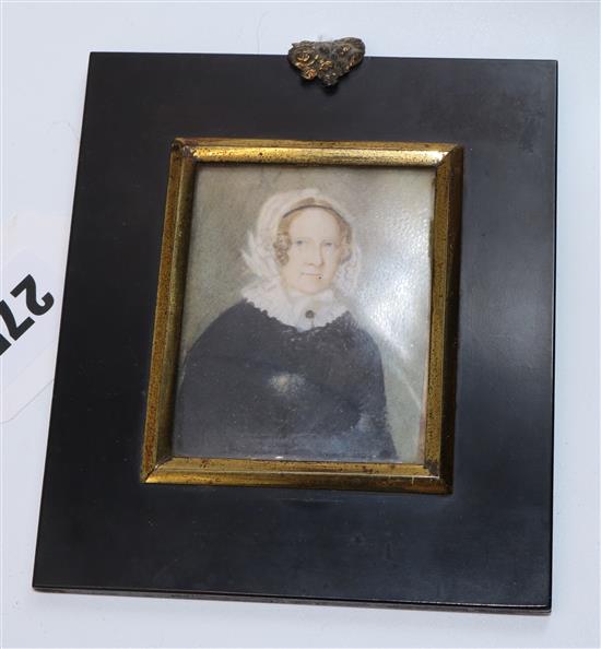 A Victorian portrait miniature on ivory of a lady wearing a white bonnet and collar and black gown, c